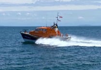 Lifeboat crew aids injured fishing crew member