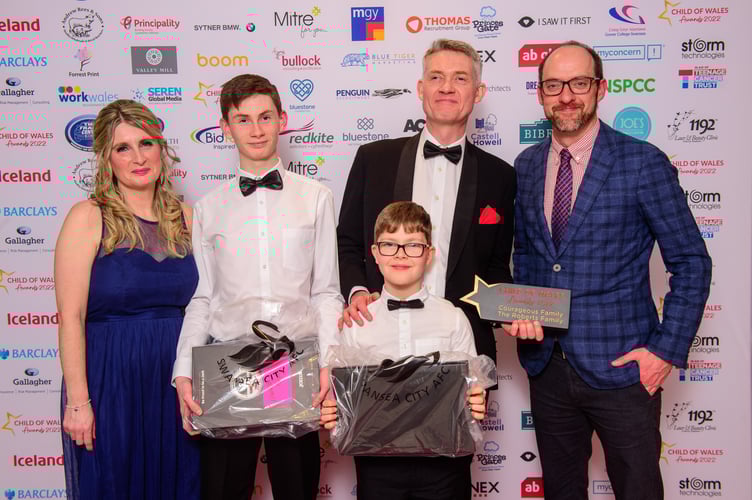 04.03.22 - Child of Wales Awards 2022, Mercure Holland House Hotel, Cardiff - Courageous Family winner The Roberts Family with James Harper, Principality Building Society