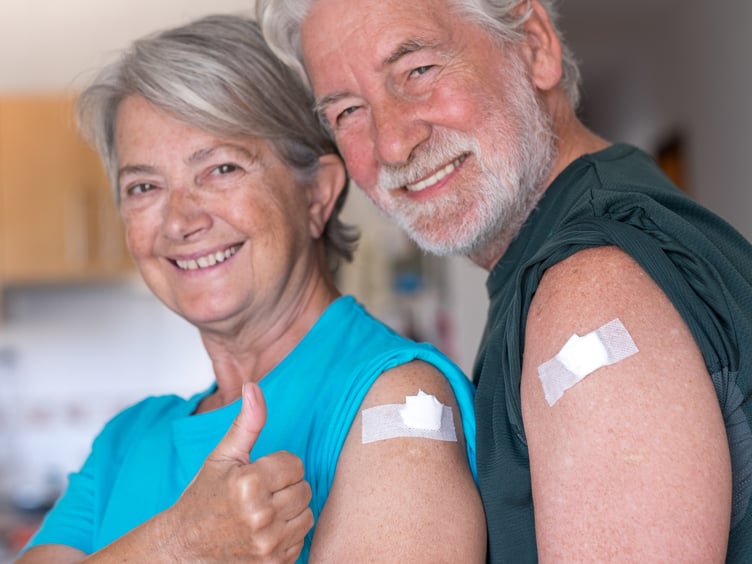 couple 70 years old smiling after receiving the booster of the coronavirus covid-19 vaccine. Concept of prevention and immunization