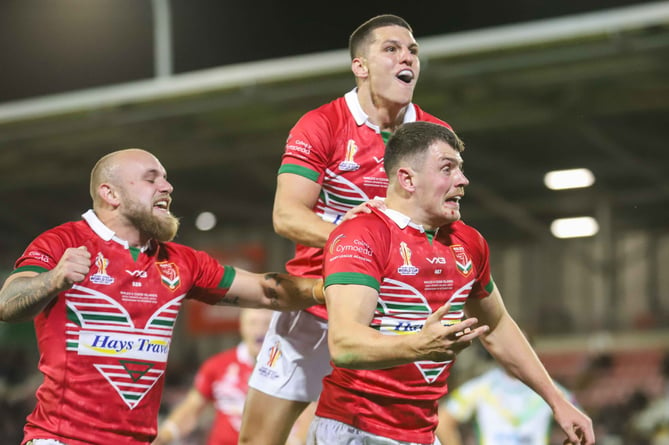 Rhodri Lloyd celebrates scoring a try against Cook Islands in Rugby League World Cup 2021