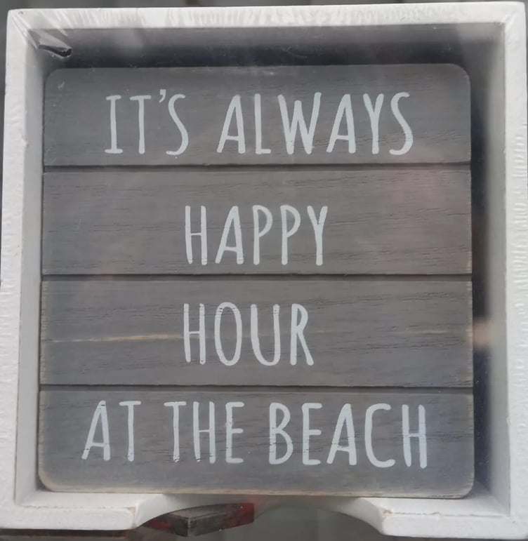 Sign: “It's always happy hour at the beach”