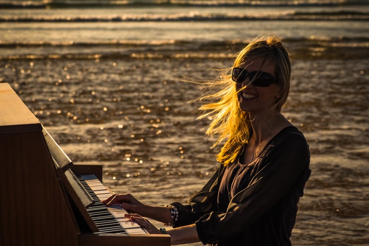 Lisa Shelmerdine Richards playing the piano at Freshwater West, Pembrokeshire