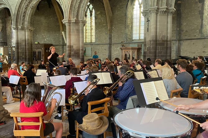 Pictured are the young musicians rehearsing before the concert with the BBC National Orchestra of Wales.