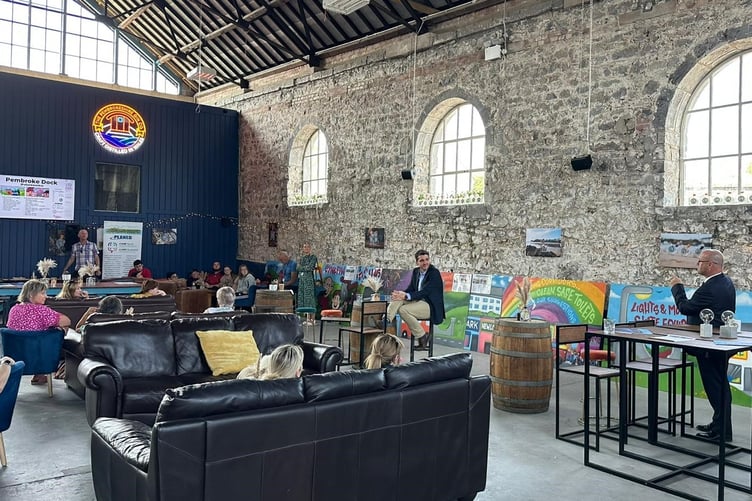 PCC Dafydd Llywelyn addressing an audience at the launch of a graffiti exhibition in the Old Market Hall, Pembroke Dock