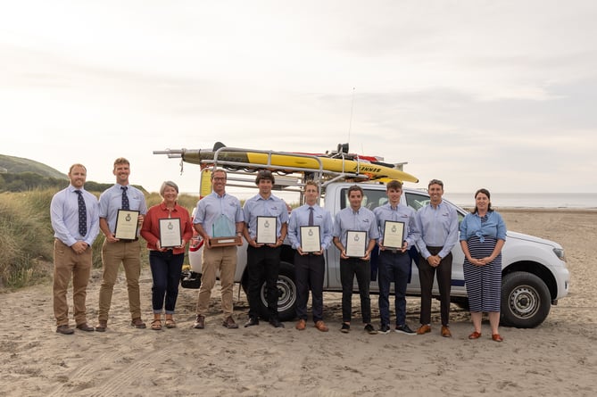 Newgale RNLI lifeguards and Ceredigion lifeguards are congratulated on receiving their Alison Saunders awards by Lifeguard Leads Pete Rooney and Jo Price.