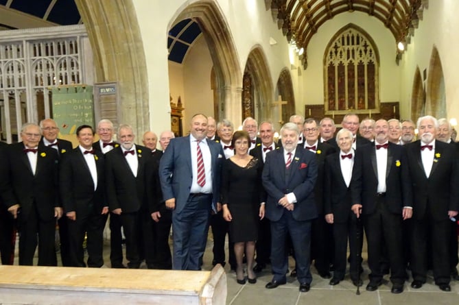 Tenby Male Choir seen with president Wynne Evans and past president Roy Noble