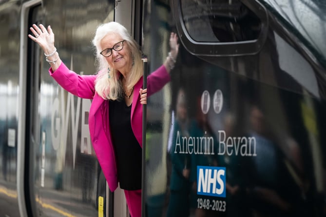 Aneira Thomas waves from the driver's cab after unveiling a train in honour of NHS founder Aneurin Bevan