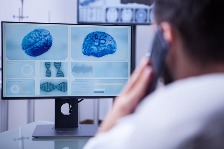 Doctor using phone and computer