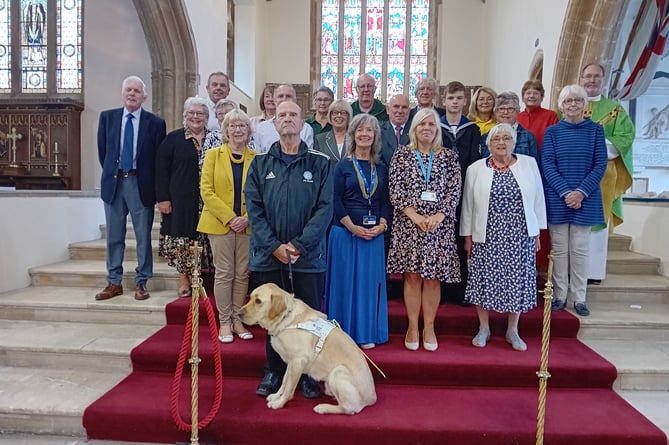 With Rector Reverend Canon Andrew Grace are representatives of some of the many organisations and charities in receipt of donations from St MaryÕs Church, Tenby funded by proceeds from the townÕs Seaview car park, which is church property.