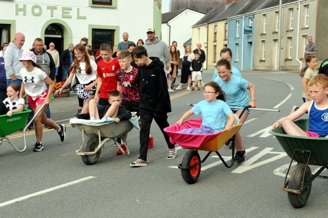 Junior wheelbarrow push through the streets of Whitland as part of Whitland Week events that culminated in the Carnival.