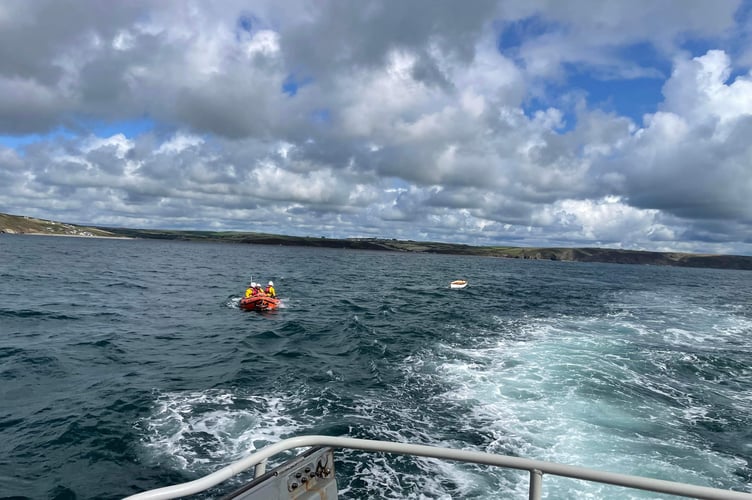Little Haven inshore lifeboat tow the capsized dinghy back to Solva harbour