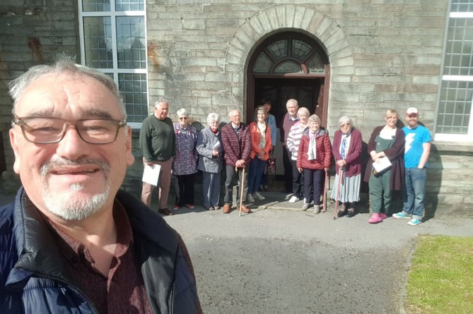 Cris Tomos and community members outside the chapel at Hermon