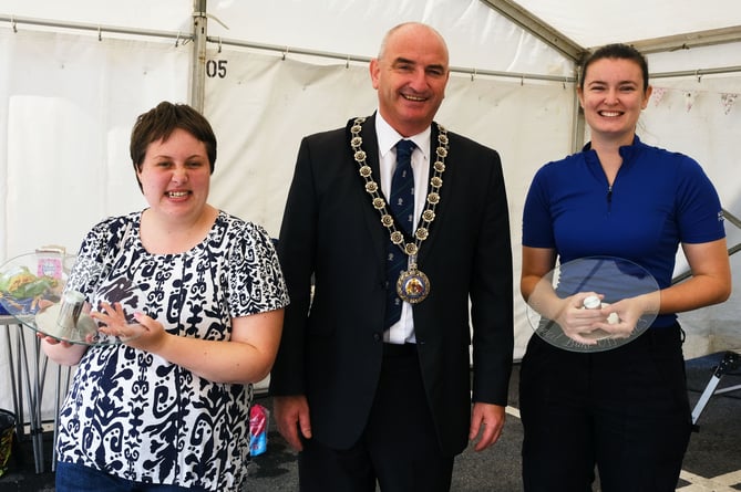 Annual Council Bake Off winners Amber Baker and Beth Hawkridge with Cllr Tom Tudor.