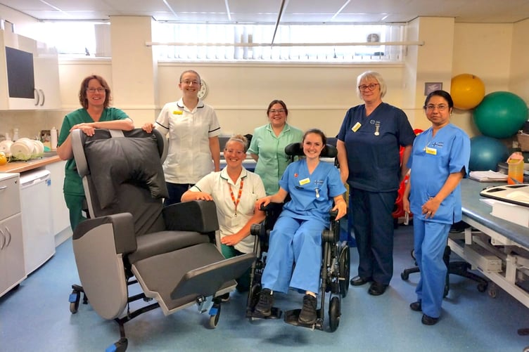 Staff from Gwenllian Ward in Glangwili Hospital with one of the specialist chairs.