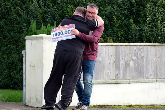 WINNING HUGS: Alan won alongside his neighbour Sean Edwards, 51, who scooped £400K
