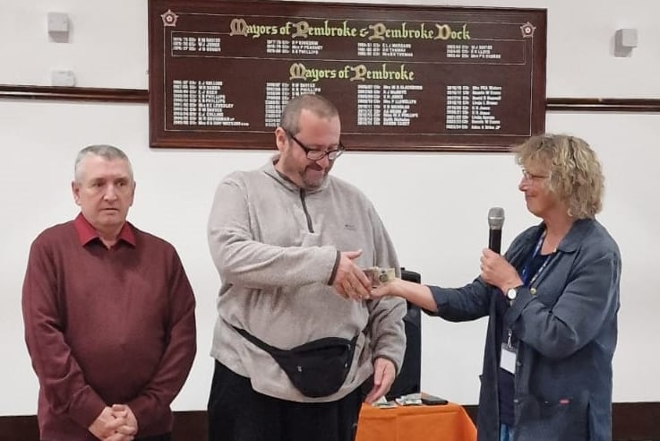 Wayne and Matthew receive a Pembroke Soup donation for Menshed from Joan Marsh