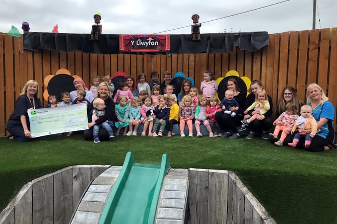 Claire Rumble, Fundraising Officer (left) with staff and children from Twts Tywi Nursery