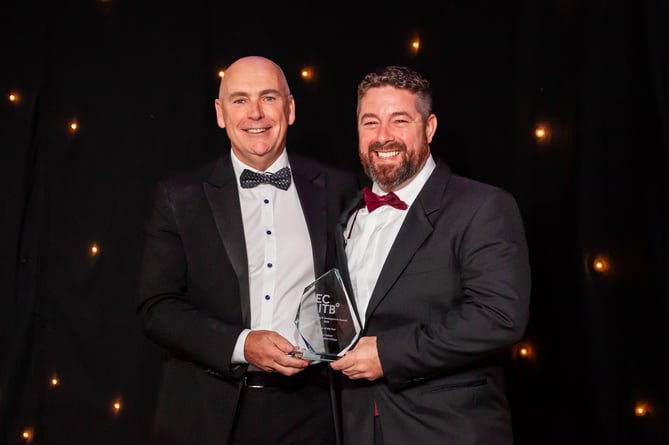 Arwyn Williams from Pembrokeshire College collecting the Scholar of the Year award on behalf of Jordan Palmer with Paul Smith from Cavendish Nuclear who sponsored the award