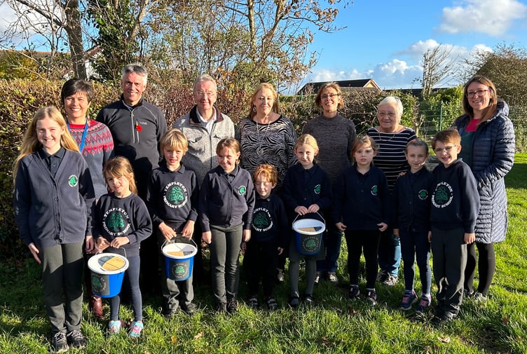 With pupils of the school are Deputy Head Mrs Sarah Arthur, Headteacher Mr Phelps, Templeton Together Committee members Amanda Lee and Mark Norris, Templeton Community Council Members Cllr Kathrin Williams and Cllr Liz Burns and Friends of Templeton School Chair Ros Canney.