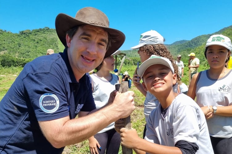 Darwin 200's Stewart McPherson planting trees to build a corridor between two important sections of Atlantic rainforest for Golden lion tamarins.