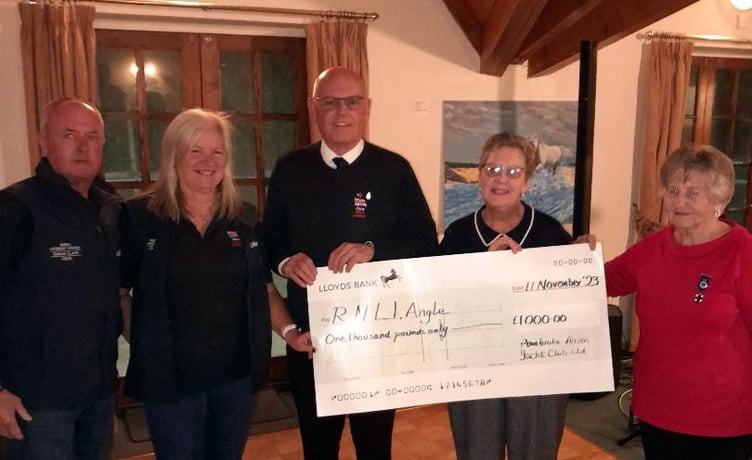 Members of the Angle branch of the RNLI being presented with the donation at Pembroke Haven Yacht Club.
