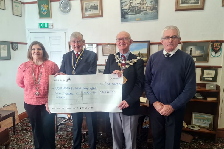 Mayor of Pembroke Cllr Aden Brinn presenting the donation to Royal British Legion District Chairman Mr Tom Brown. Also in the photo is the Mayoress Mrs Claire Dunfresnoy and Royal British Legion District Treasurer Mr John Mycroft.