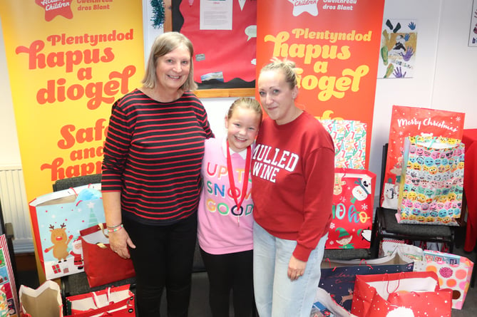 Sue Marsden, Grace and Kirsty with the presents in Llanelli office of Action for Children