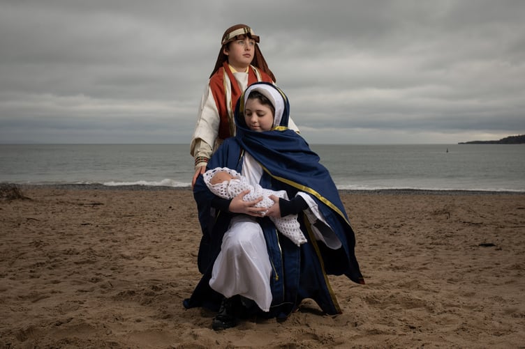 Pupils from St Teiloâs Catholic Primary School, located in the popular seaside resort of Tenby, act out scenes from their nativity plays before they break for Christmas on Friday. All schools will have finally broken up for the Christmas holidays by either today or tomorrow. In the image Isabella Fairile plays Mary holding baby Jesus (bottom) and Euan Monan as Joseph (top) from Class 4,  on Tenbyâs South Beach, located just a stones throw from the school.