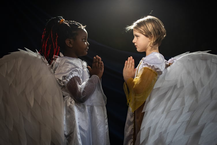 Pupils from St Teiloâs Catholic Primary School, located in the popular seaside resort of Tenby, act out scenes from their nativity plays before they break for Christmas on Friday. All schools will have finally broken up for the Christmas holidays by either today or tomorrow. In the image, two angels, Kimberly Mavindidze (left) and Hazel Monan (right) from Class 3 show off their wings.