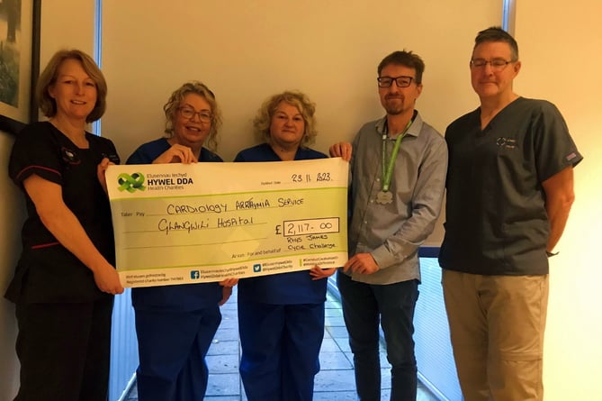 Receiving the cheque from Rhys James are Dr Adrian Raybould, Consultant Cardiologist; Jennifer Matthews, Advanced Nurse Practitioner Arrhythmia; Nerys James, Cardiac and Respiratory Healthcare Sciences Manager and Andrea Evans, Clinical Nurse Specialist Arrhythmia.