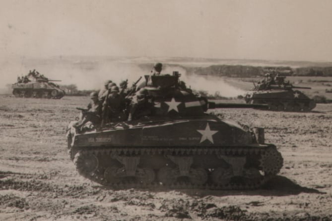 Sherman tanks of the US Sixth Armored Division take part in a training exercise at Castlemartin prior to the Normandy landings. The woods by Brownslade are in the background.