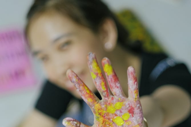 Happy girl with painted hand