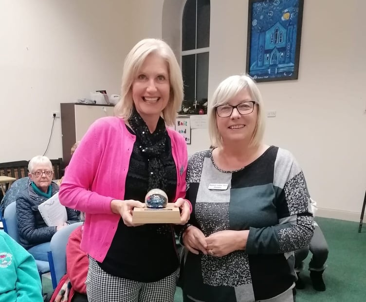 Chairlady Sandra Western presents the paperweight in memory of Grace Lewis to choir secretary Alison Davies.