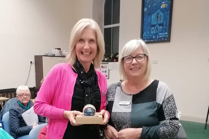 Chairlady Sandra Western presents the paperweight in memory of Grace Lewis to choir secretary Alison Davies.