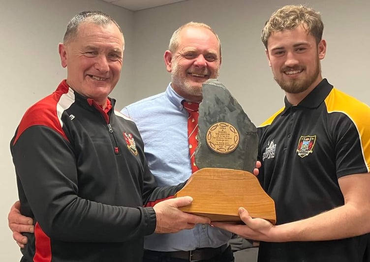 Willington brothers hand over the Slate trophy to winning St David's skipper.