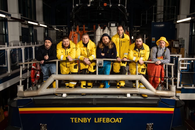 Crew members from Tenby RNLI station pose on the back of the Haydn Miller, juxtaposing old and new.