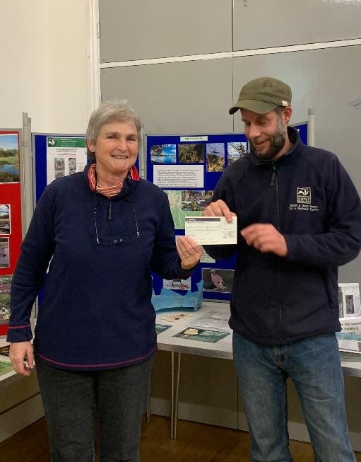 Clare Walker, Chair of the South Pembrokeshire Local Group of the Wildlife Trust, presents Trust Reserves Manager, Nathan Walton, with a cheque for £500