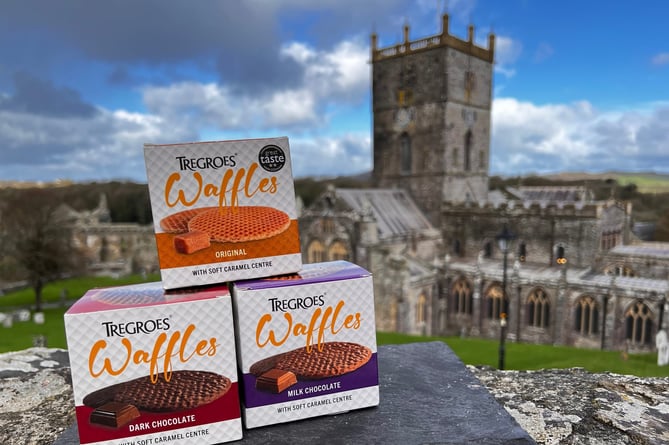 Packs of Tregroes Waffles stacked against the backdrop of the iconic cathedral at St Davids, Pembrokeshire.