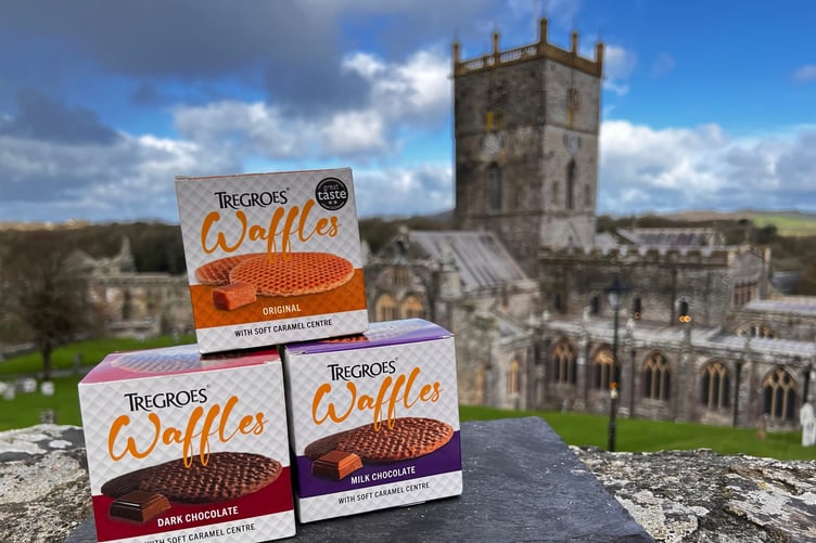 Packs of Tregroes Waffles stacked against the backdrop of the iconic cathedral at St Davids, Pembrokeshire.