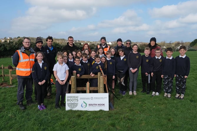 Johnston pupils plant trees in the school grounds with the support of Tom Bean and Will Whittington of Pembrokeshire Coast National Park Authority, along with Hamad Al Samra and the team from South Hook LNG Terminal.