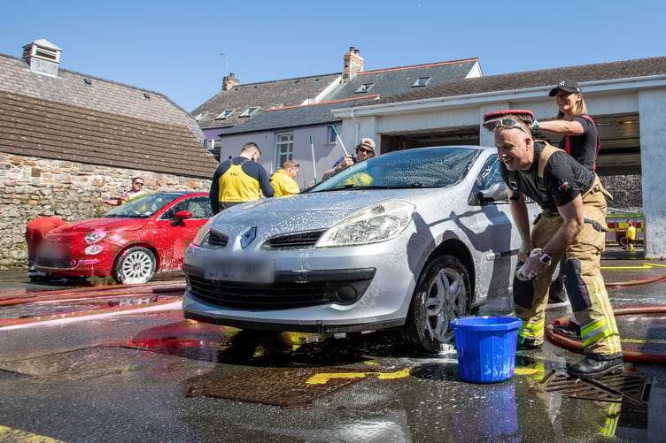 Firefighters from the on-call fire crew at Tenby Fire Station and Tenby RNLI Station, made the most of the hot, sunny weather over the weekend with a fundraising car wash to raise money for the RNLI. The fire station, based in the heart of the hugely popular seaside resort of Tenby, Pembrokeshire, is well known for the fundraising activities they do. The car wash also attracted fellow emergency service, The Welsh Ambulance.