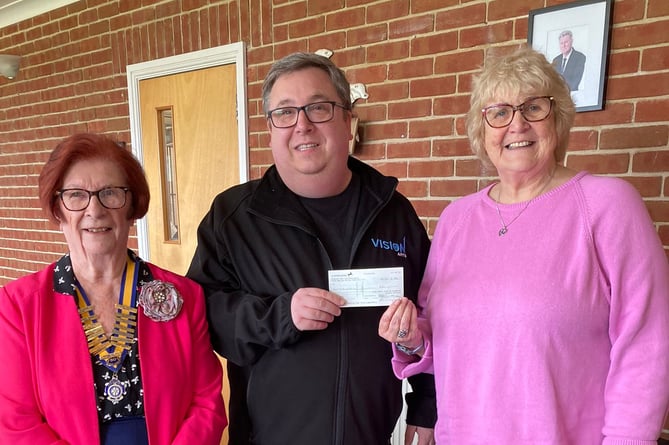 Drew Baker of The Vision Theatre Company accepting a donation from Dot Edwards and President of Inner Wheel of Pembroke June Willcocks