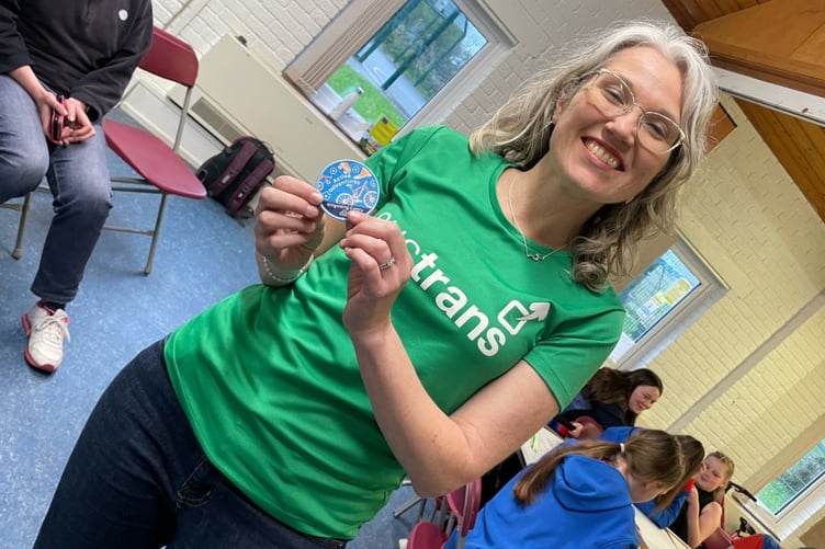 Christine Boston holding Active Adventures badge