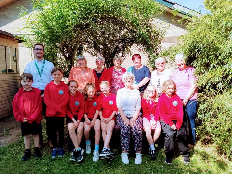 Children of Stepaside school with Headmaster Mr Peter Jones at the presentation of the 'Buddy bench’ kindly donated by Kilgetty WI.