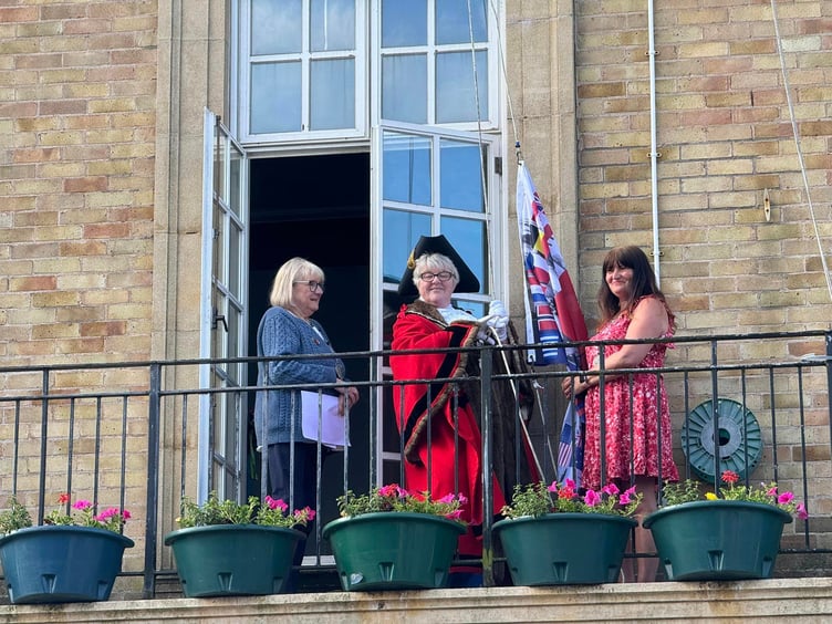 Mayor Cllr Maria Williams raising the D-Day flag Pembroke Dock Pater Hall.