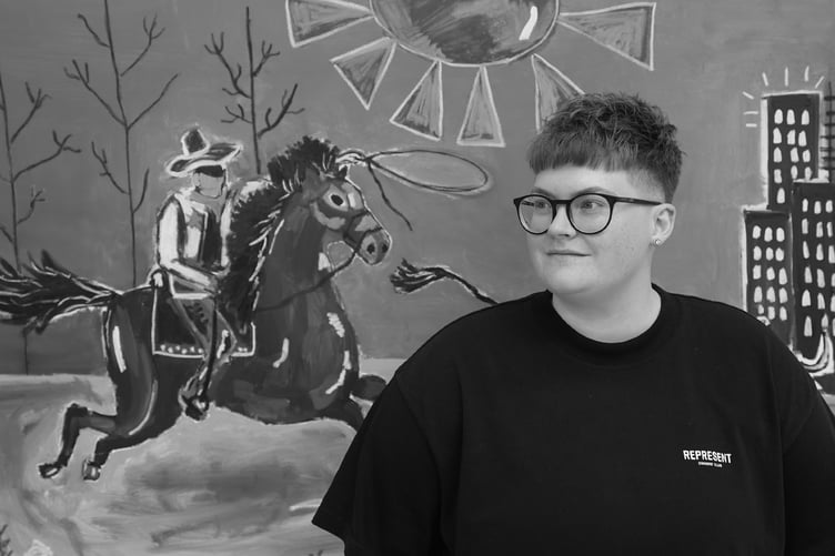 Caitlin Flood-Molyneux with one of her selected artworks from her tour ‘Going Away in Order To Return’