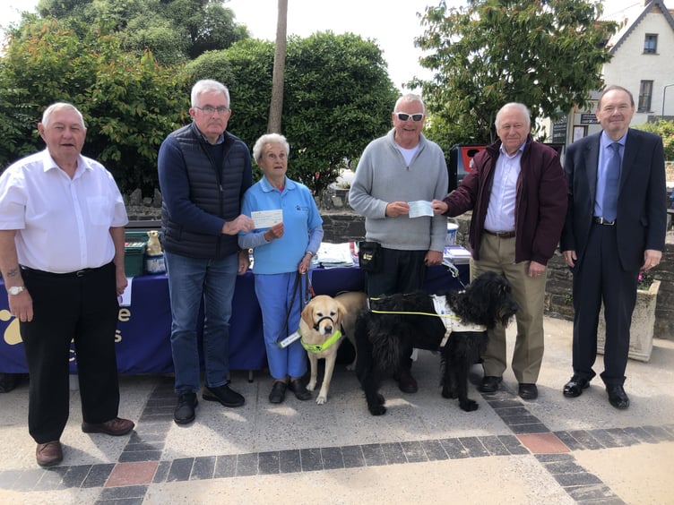 Narberth Masonic Lodge Worshipful Master W. John Mycroft presenting a cheque to Eva Rich, Guide Dogs Cymru Pembrokeshire Branch Organiser with guide dog Nancy; Bro. Mike John presenting a cheque to his brother, Anthony (Adge) John with guide dog Skip; Bros. Richard Fanus and Andrew Walker.