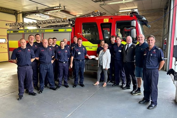 Pictured along with Tenby Station Firefighters are Saundersfoot NYDS Committee secretary Lynn Knibbs, Treasurer Anthony Mattick and Chairman Chris Williams.