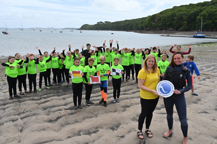 Sara Richards from the Port of Milford Haven (front left) and Miyah Periam (front right), Senior Instructor at Windswept, with Year 6 pupils from Cleddau Reach School at Dale beach.