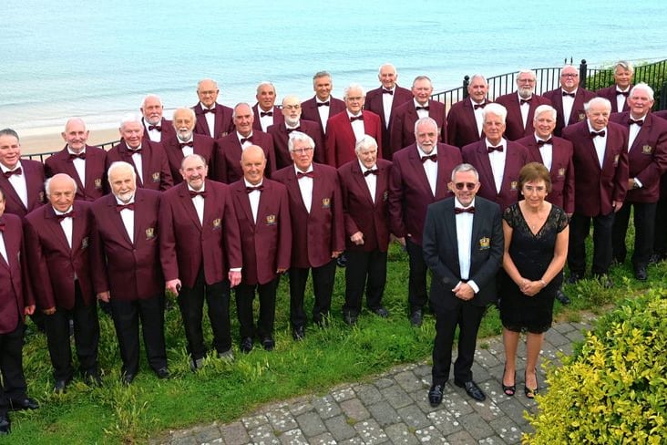 Members of Tenby Male Choir with musical director Paul Rapi and accompanist Jill Williams.